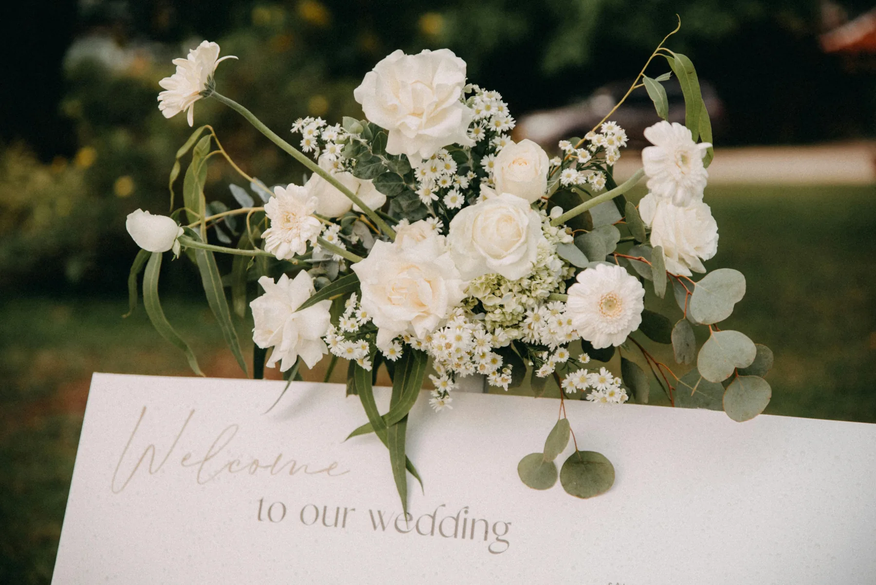 A welcome sign at the entrance to a wedding